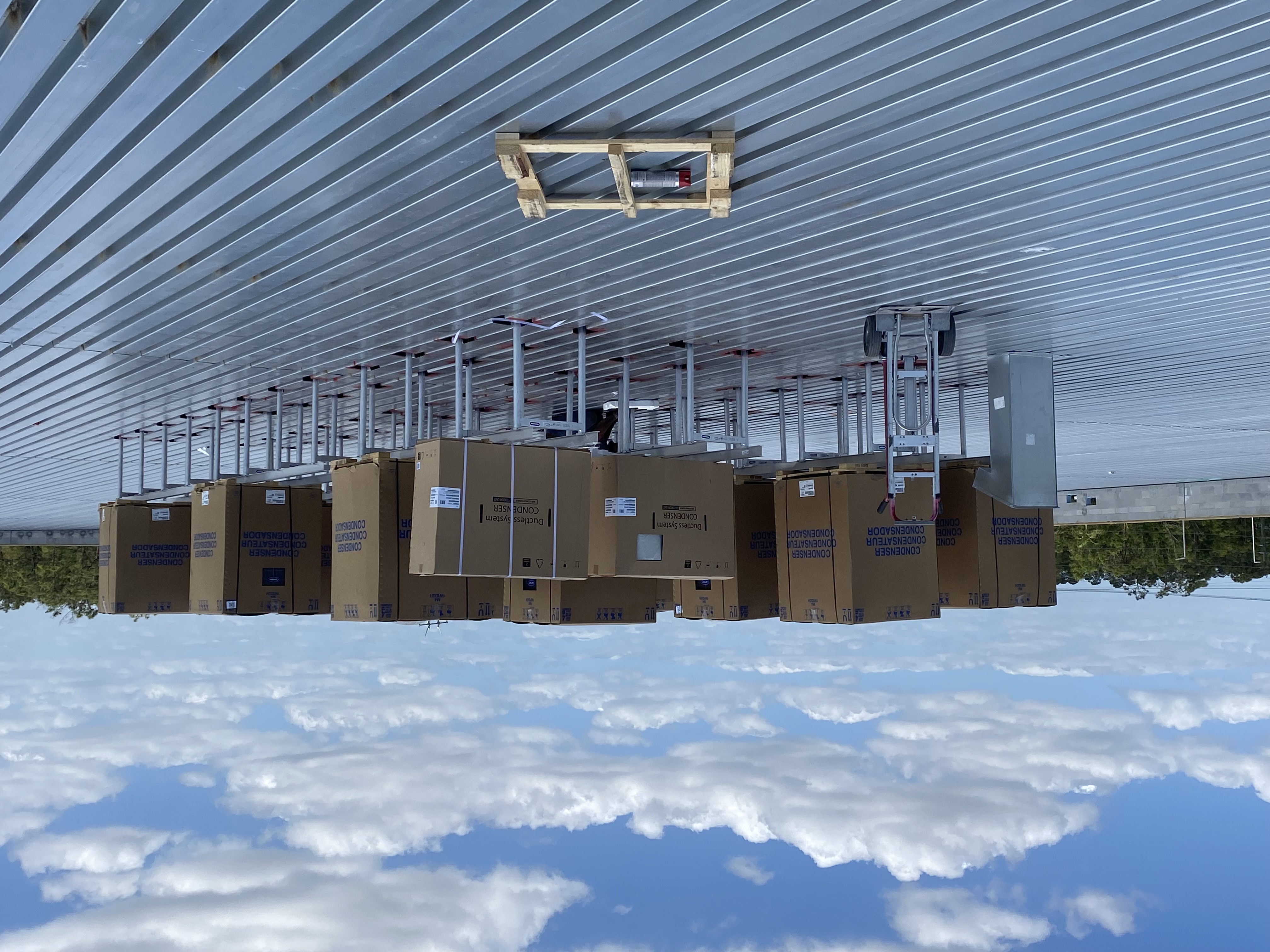 Condensing units staged on equipment stands on a new-construction rooftop