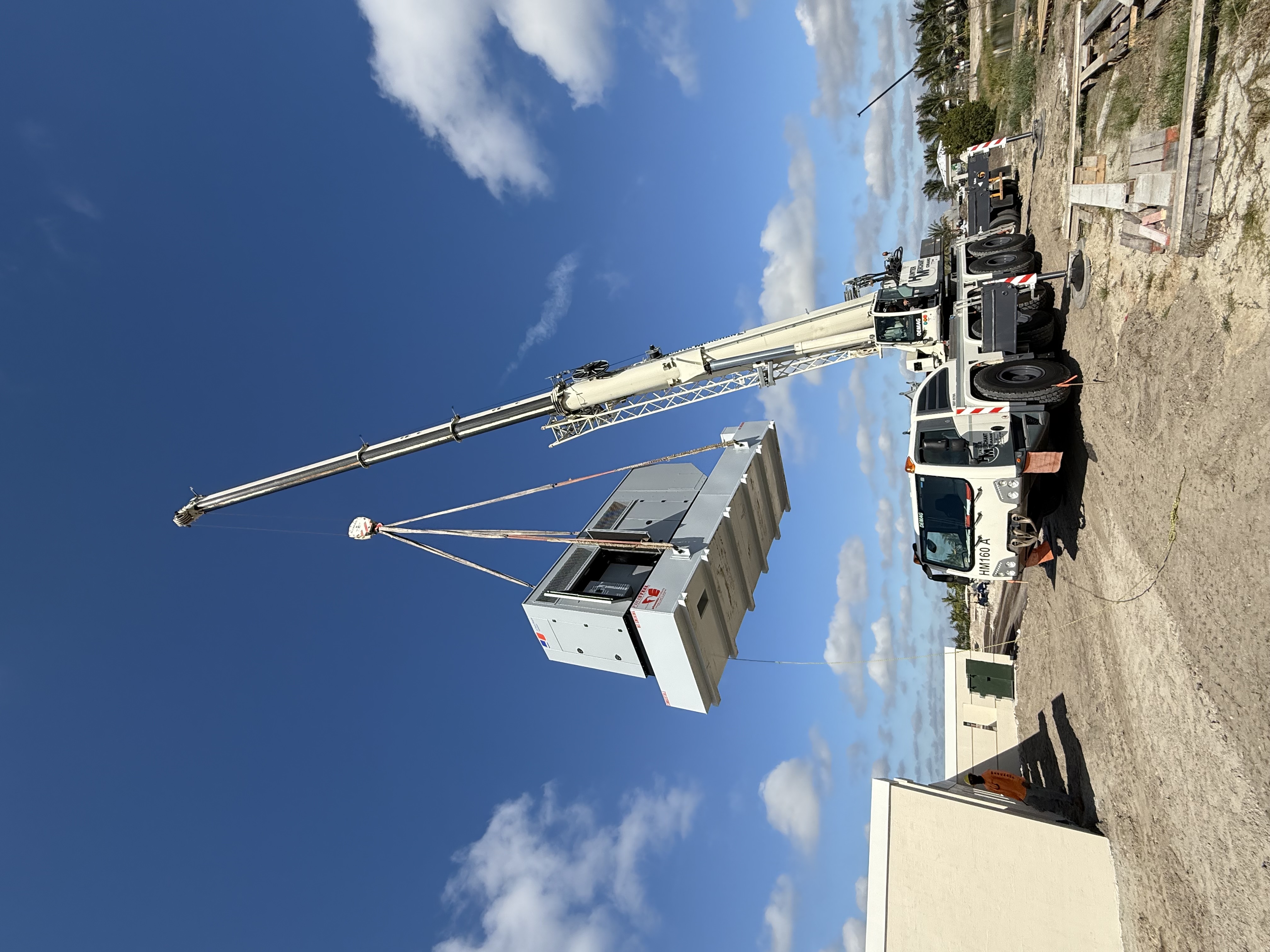 Crane lifting packaged mechanical equipment into place at the Solid Waste Authority