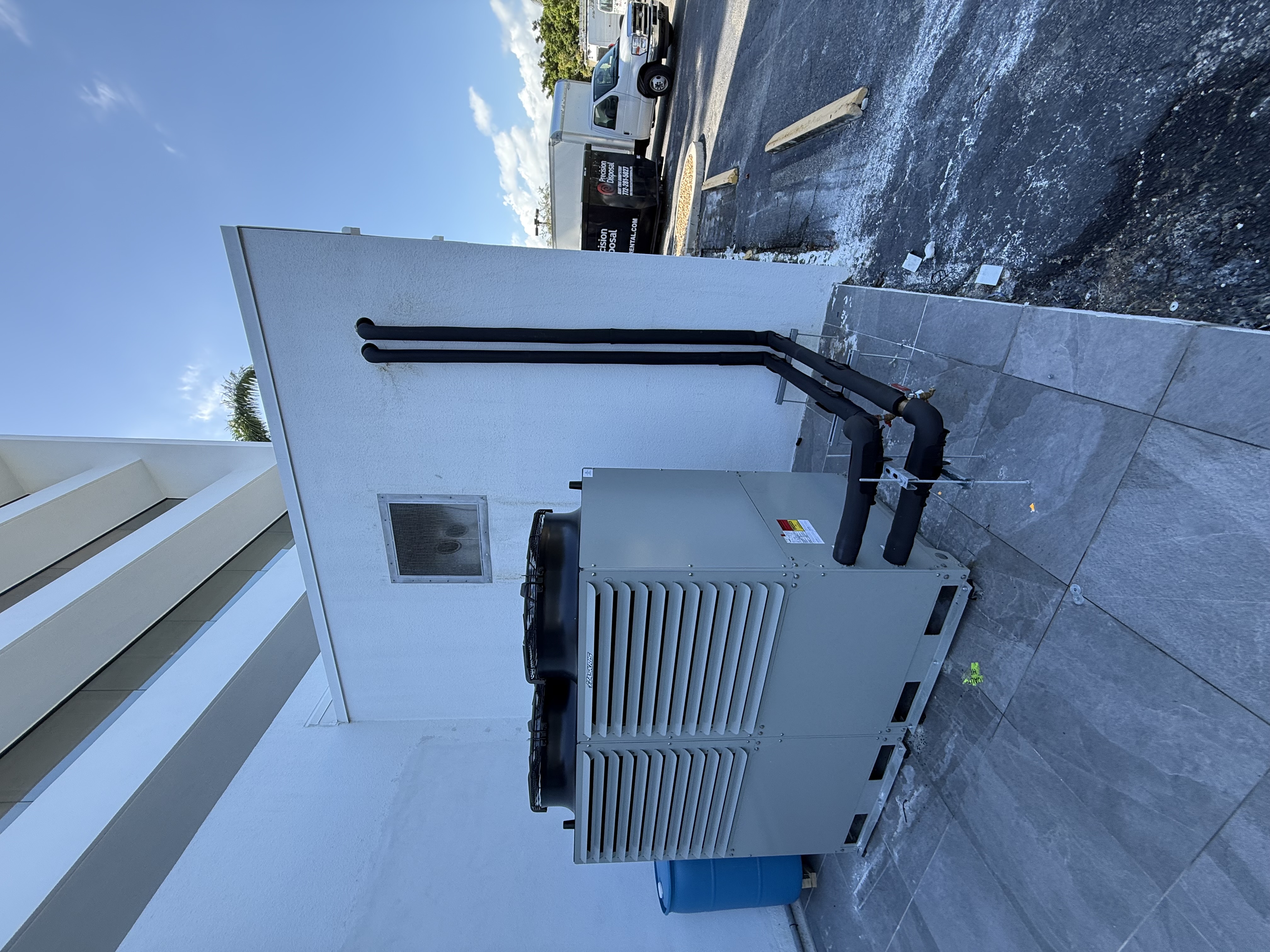 Packaged chiller installation with insulated piping at a commercial building