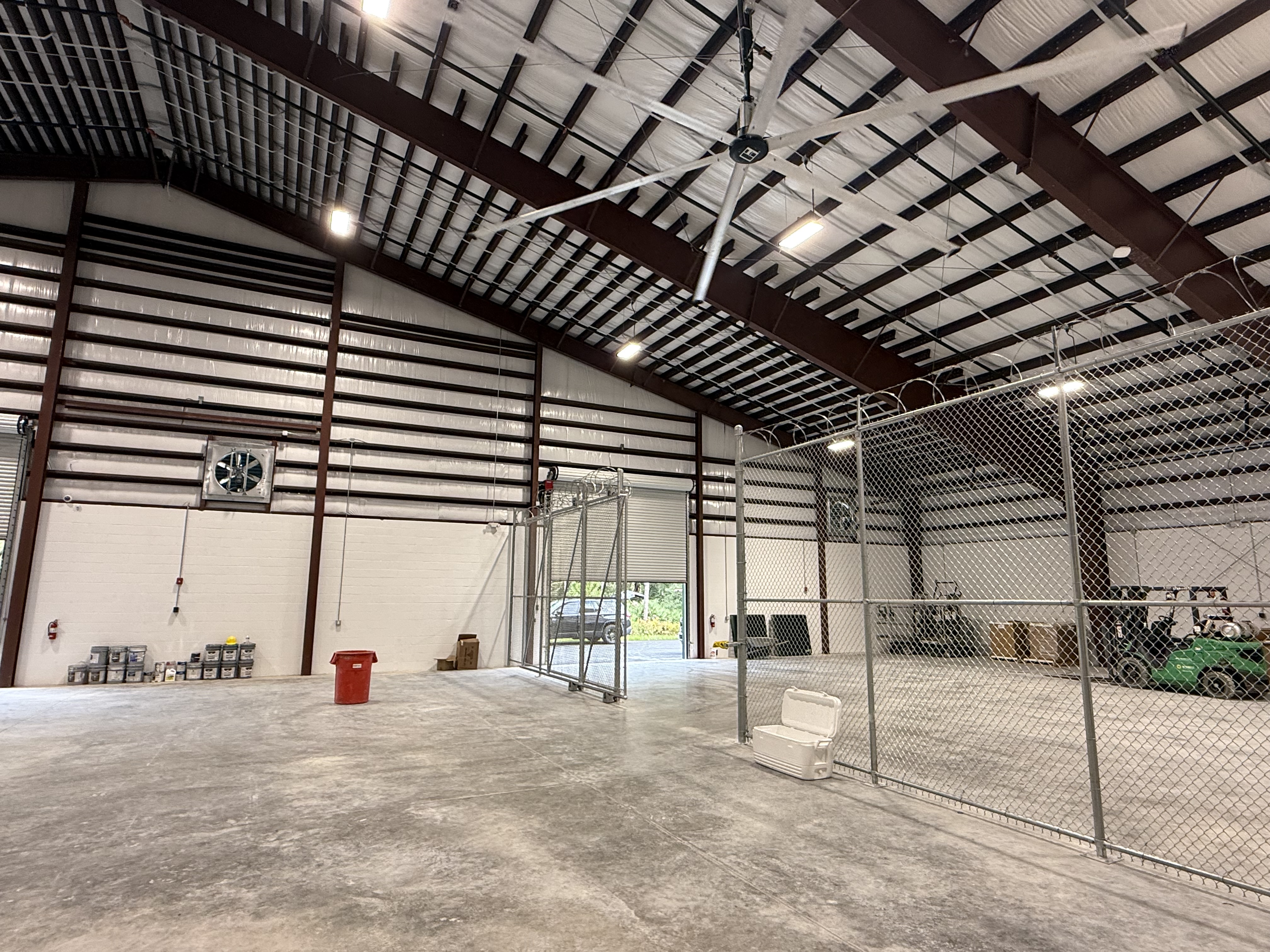 Pre-engineered metal building interior with HVLS fan and ventilation at H&E Equipment Services